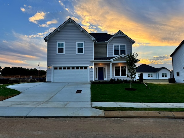 view of front of property with a yard and a garage