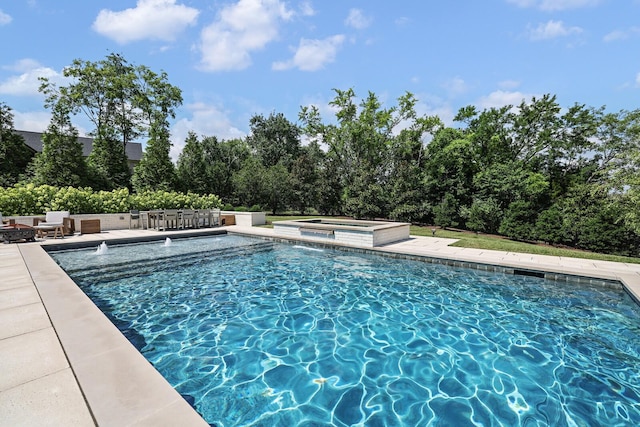 view of swimming pool with an in ground hot tub and a patio area