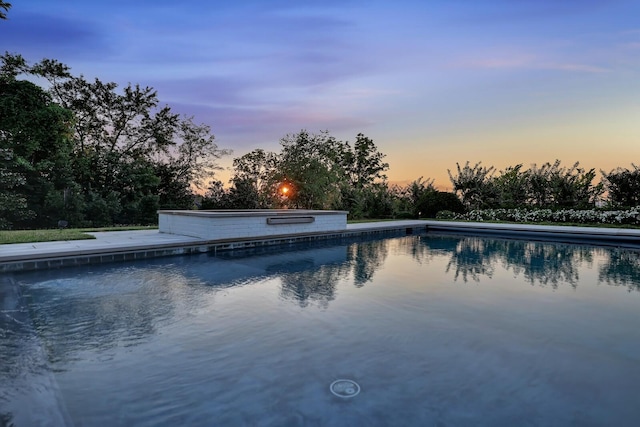 view of pool at dusk