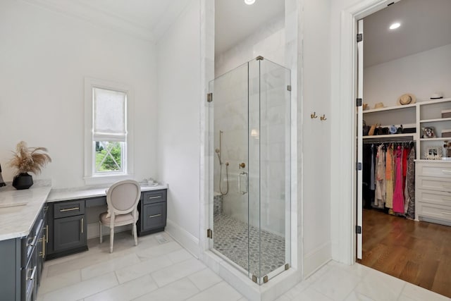 bathroom with crown molding, tile patterned floors, vanity, and a shower with door