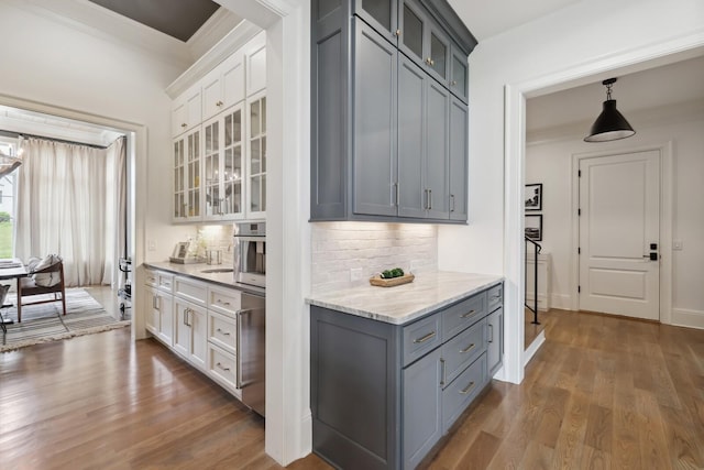 kitchen featuring gray cabinets, hanging light fixtures, dark hardwood / wood-style floors, tasteful backsplash, and white cabinets