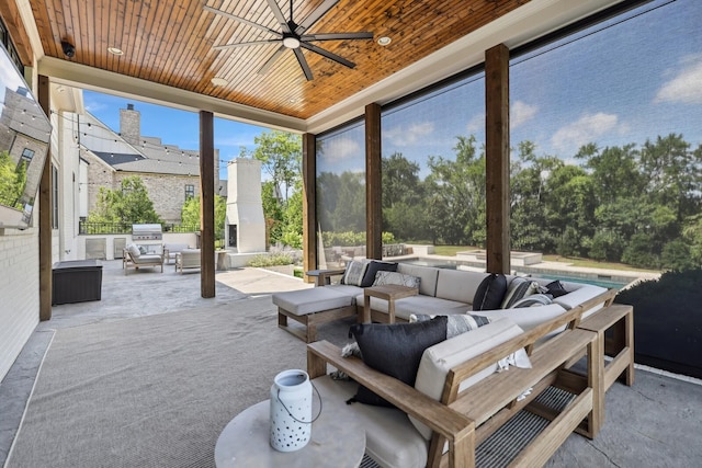 view of patio with exterior kitchen, an outdoor hangout area, and ceiling fan