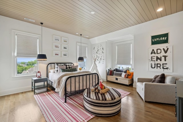 bedroom with hardwood / wood-style floors, multiple windows, and wooden ceiling