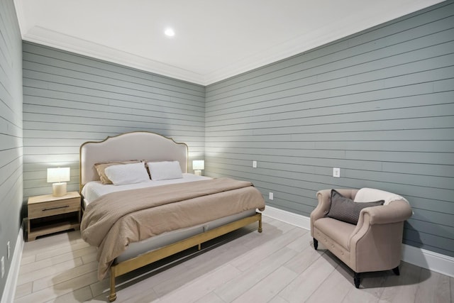 bedroom with crown molding and light hardwood / wood-style flooring