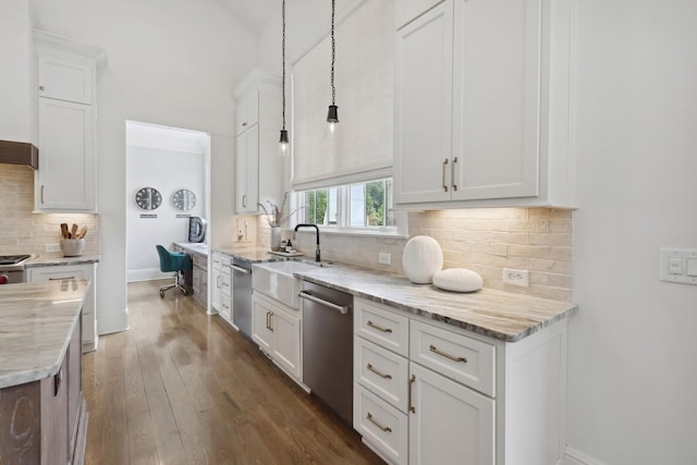 kitchen featuring light stone counters, hanging light fixtures, stainless steel dishwasher, and white cabinets