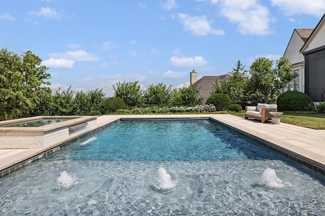 view of pool with an in ground hot tub, pool water feature, and a patio