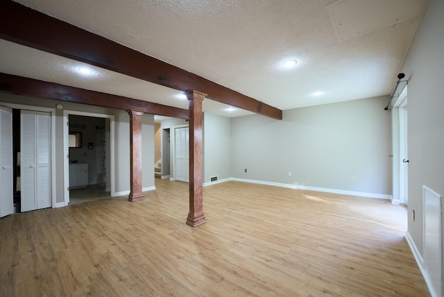 basement with light hardwood / wood-style floors and a textured ceiling