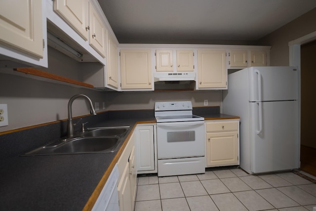 kitchen with white cabinets, white appliances, sink, and light tile patterned floors