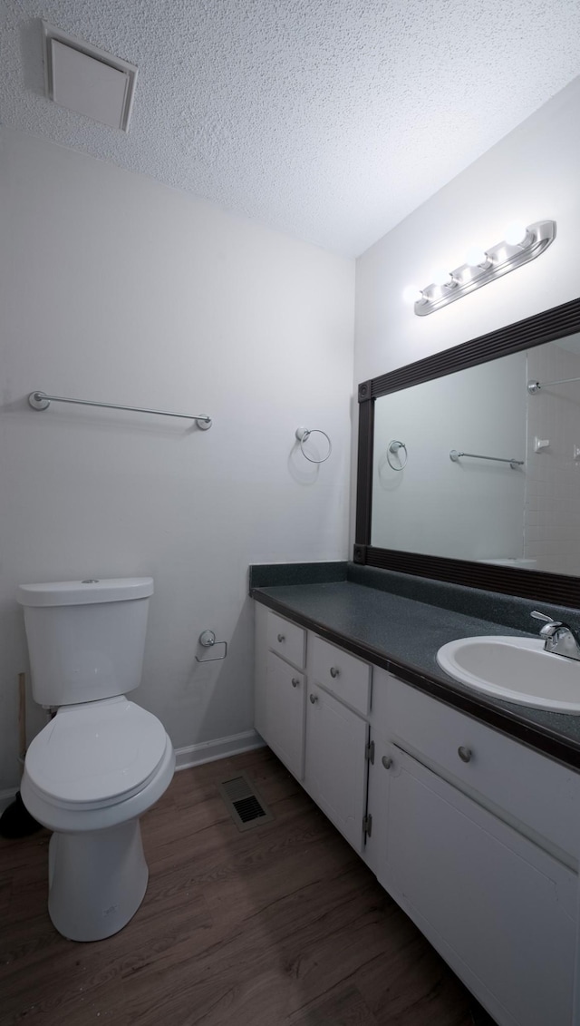 bathroom with vanity, hardwood / wood-style floors, and a textured ceiling