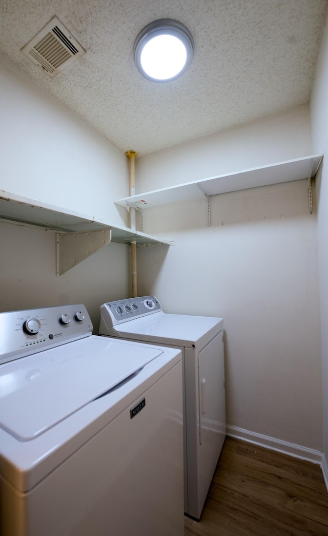 laundry room featuring dark wood-type flooring and independent washer and dryer