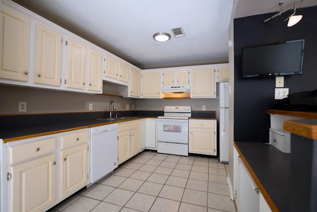 kitchen with light tile patterned flooring, sink, white cabinetry, a textured ceiling, and white appliances