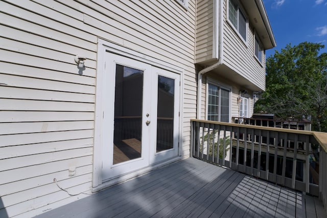 wooden terrace with area for grilling and french doors