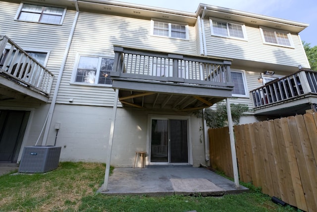 back of property with cooling unit and a patio