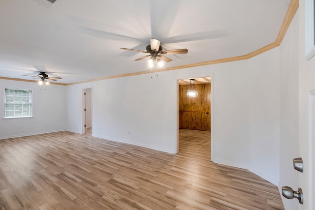 empty room featuring ceiling fan, ornamental molding, and light wood-type flooring