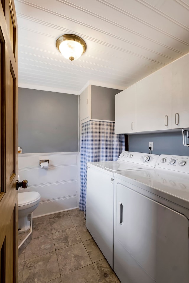 washroom featuring separate washer and dryer and wooden walls