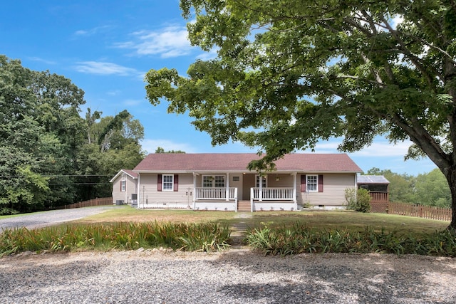 single story home featuring covered porch, a front lawn, crawl space, and fence