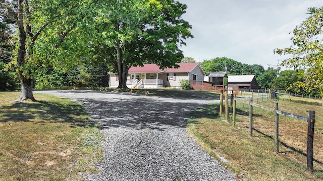 view of front of home featuring a front yard and covered porch