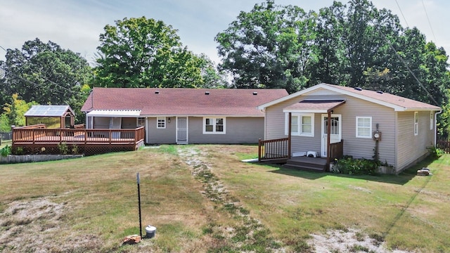 view of front of home with a front yard and a wooden deck