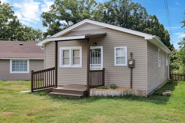 back of house with a yard and a deck