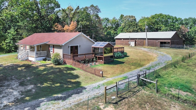 view of front of property featuring a deck and a front lawn