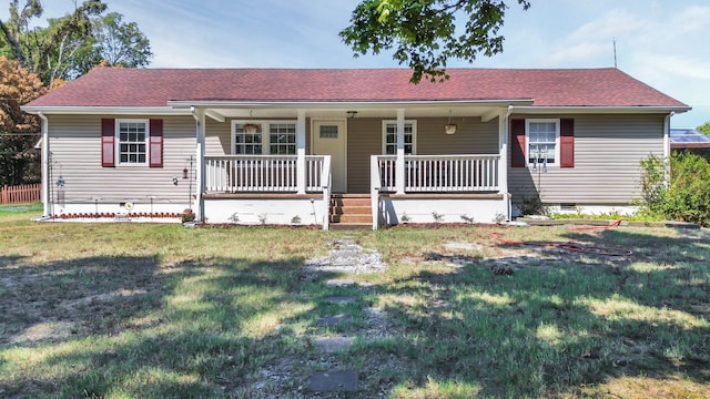 ranch-style house with a porch and a front lawn