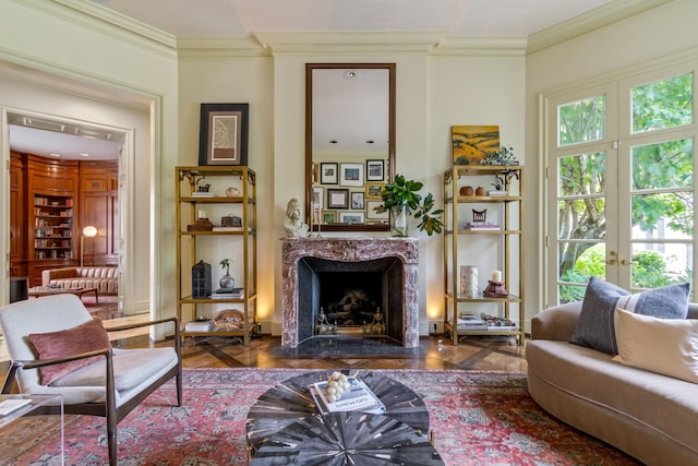 living area featuring crown molding, a healthy amount of sunlight, and french doors