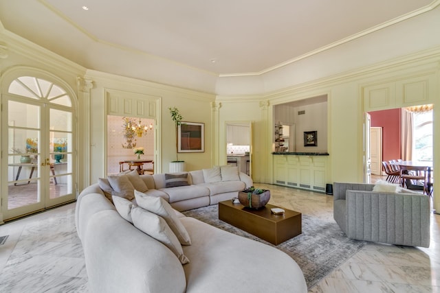 living room featuring crown molding and an inviting chandelier