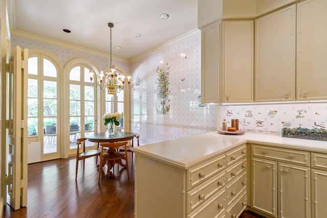 kitchen with crown molding, kitchen peninsula, pendant lighting, dark hardwood / wood-style flooring, and cream cabinets