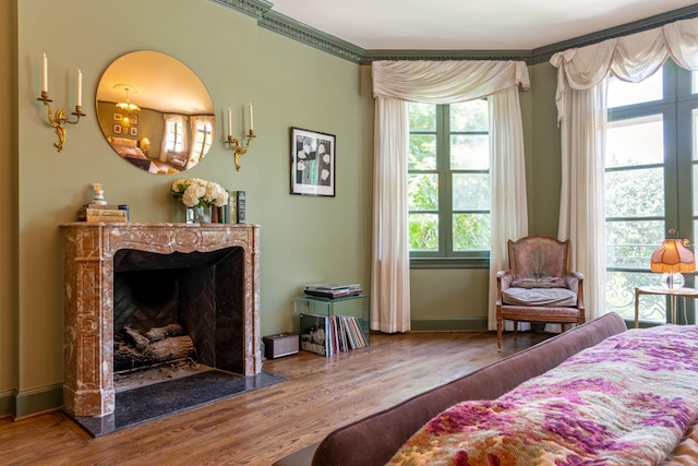 bedroom featuring crown molding, multiple windows, and hardwood / wood-style flooring