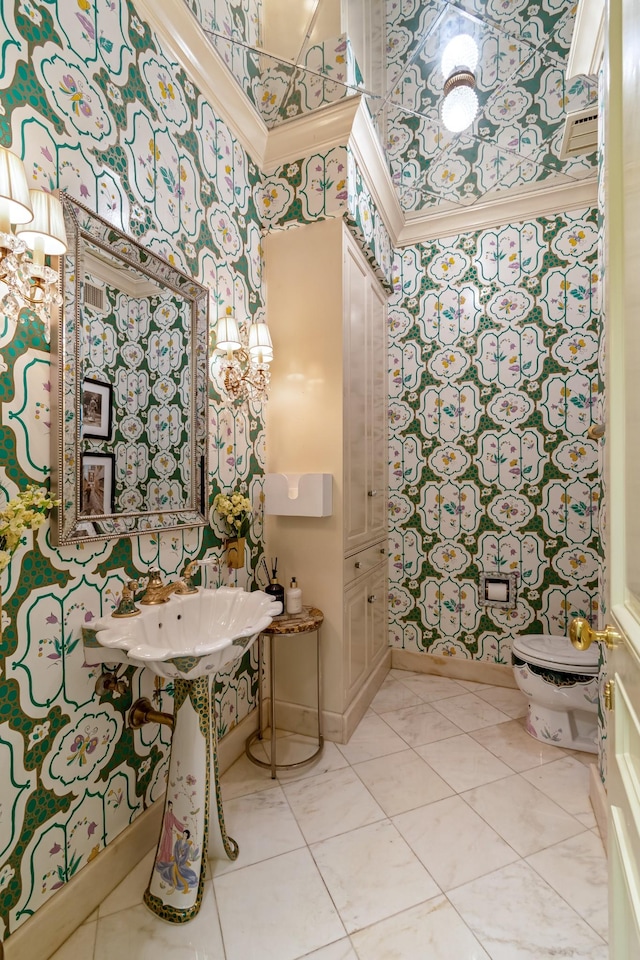 bathroom featuring a high ceiling, tile patterned floors, toilet, and crown molding