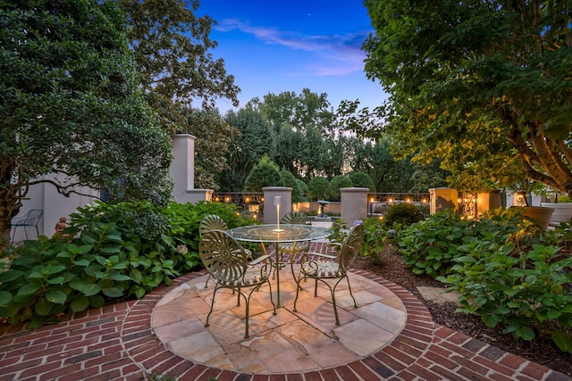 view of patio terrace at dusk