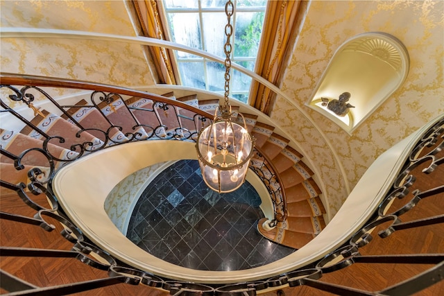 stairs featuring an inviting chandelier