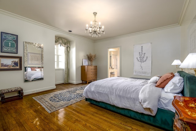 bedroom with dark wood-type flooring, connected bathroom, a notable chandelier, and ornamental molding