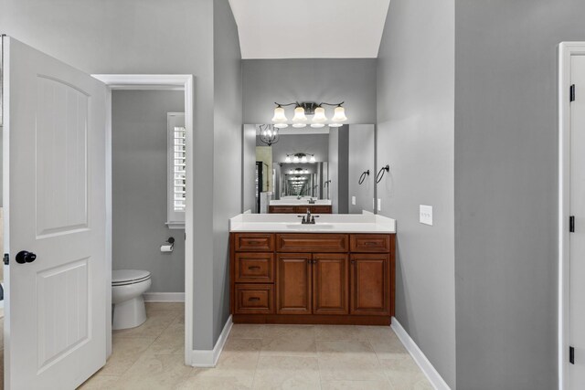 bathroom featuring vanity, tile patterned flooring, and toilet