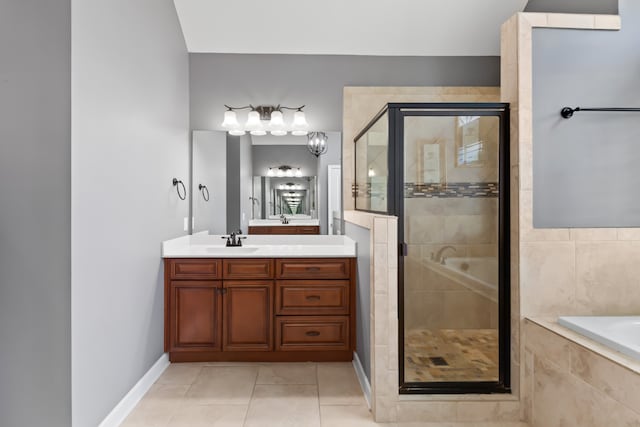 bathroom featuring plus walk in shower, vanity, and tile patterned flooring