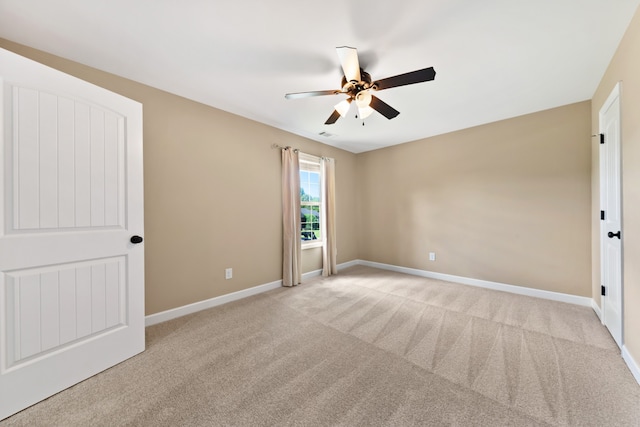 empty room with light colored carpet and ceiling fan