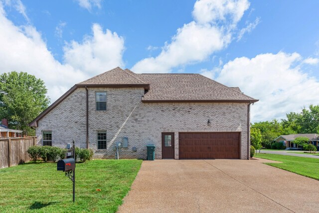701 Vanview Dr, Lebanon, TN 37087 - view of property exterior with brick siding, concrete driveway, roof with shingles, a garage, and a yard