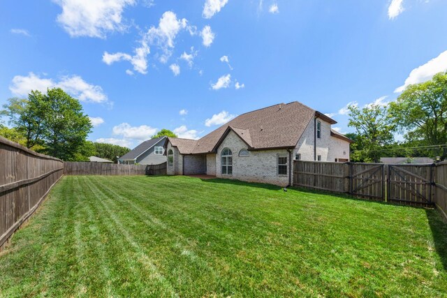 701 Vanview Dr, Lebanon, TN 37087 - rear view of property featuring a lawn, brick siding, and a fenced backyard