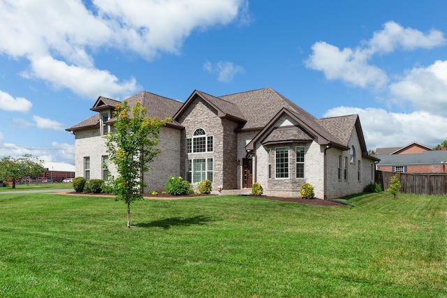 french provincial home with a front yard