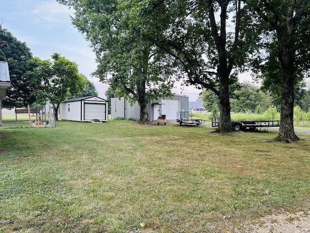 view of yard with a garage and an outdoor structure