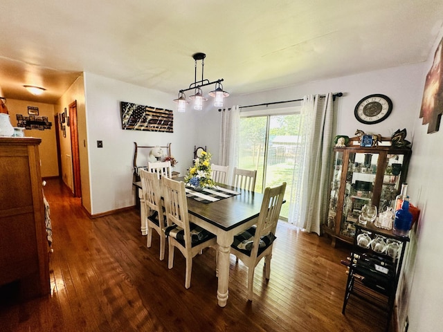 dining space with dark hardwood / wood-style flooring