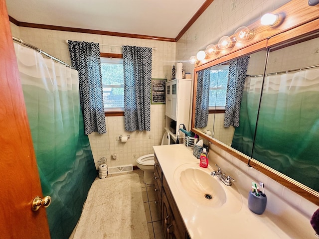 bathroom featuring toilet, crown molding, tile walls, vanity, and tile patterned flooring