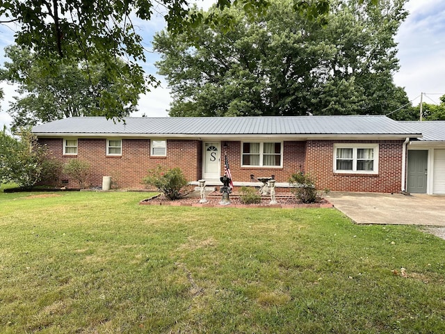 single story home featuring a garage and a front yard