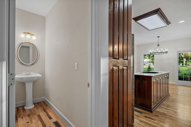 bathroom featuring wood finished floors, visible vents, and baseboards