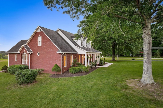 view of side of home with brick siding and a lawn