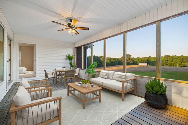 sunroom featuring ceiling fan