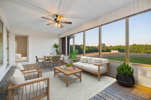 sunroom / solarium featuring ceiling fan