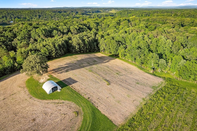 drone / aerial view featuring a wooded view