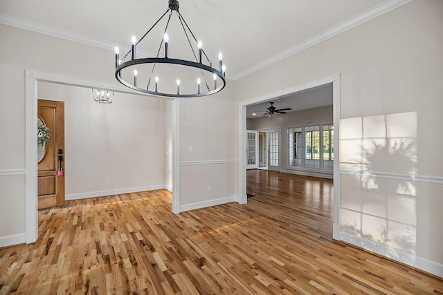 unfurnished dining area featuring ornamental molding, light wood-type flooring, and baseboards