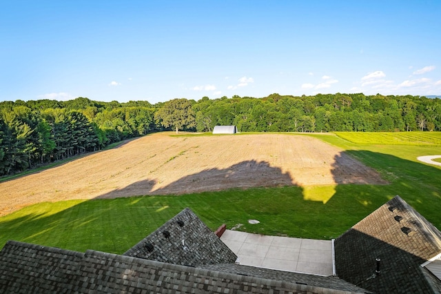 view of yard with a forest view and golf course view